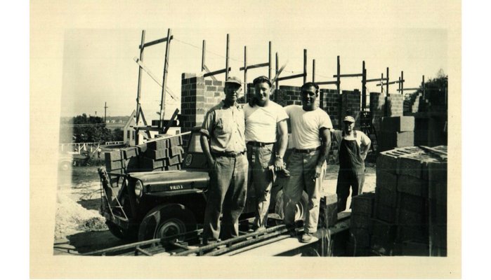 Some of the earliest members of the Flanders Fire Department work to build their firehouse a couple years after the department was established in 1948. The department is celebrating its 65th anniversary on Saturday. COURTESY OF FLANDERS FIRE DEPARTMENT