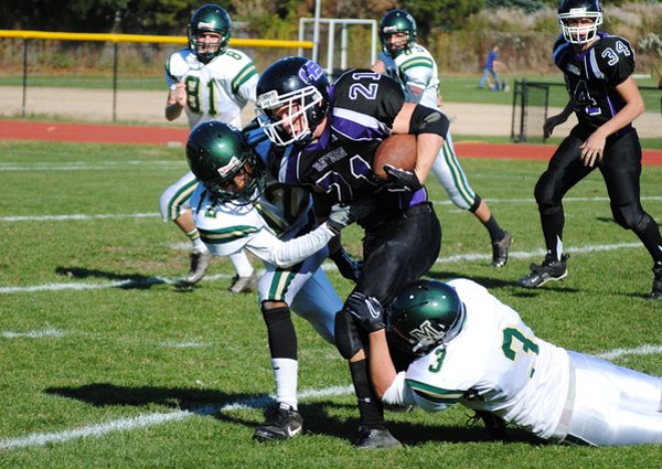 Two Mercy tacklers try to bring down Dylan Flynn. BRETT MAUSER PHOTOS
