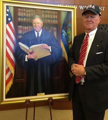  surrounded by his family during the unveiling of his portrait at the Supreme Court Building in Riverhead. DANA SHAW