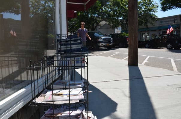 Free magazines line the streets in Southampton Village during the summer months. GREG WEHNER