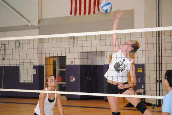 Stephanie Salomon drills a serve during practice.