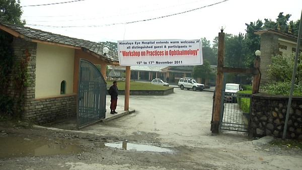 Entrance to the Himalayan Eye Hospital with the welcome banner.
