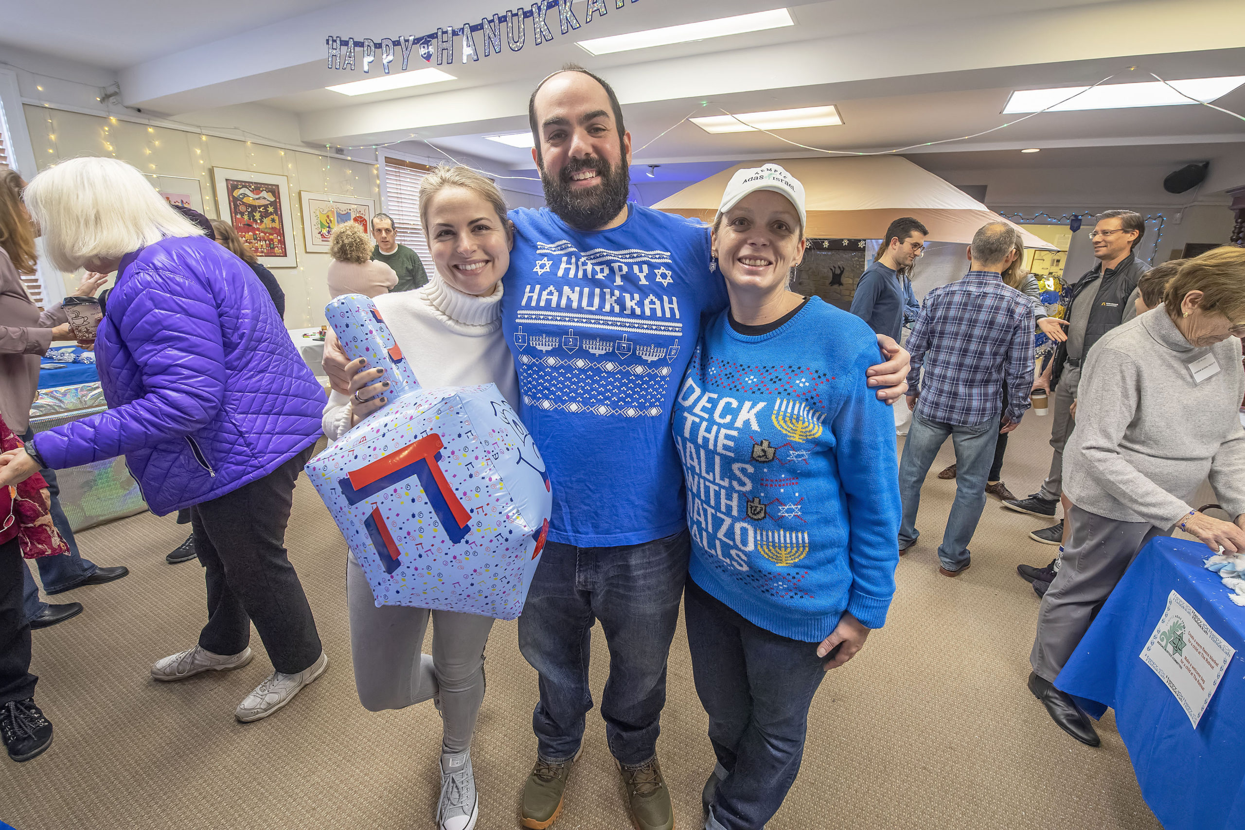 Lu Geffen, Rabbi Dan Geffen and Ilyse LaBue during the annual Hanukkah Party at Temple Adas Israel on Sunday.  MICHAEL HELLER