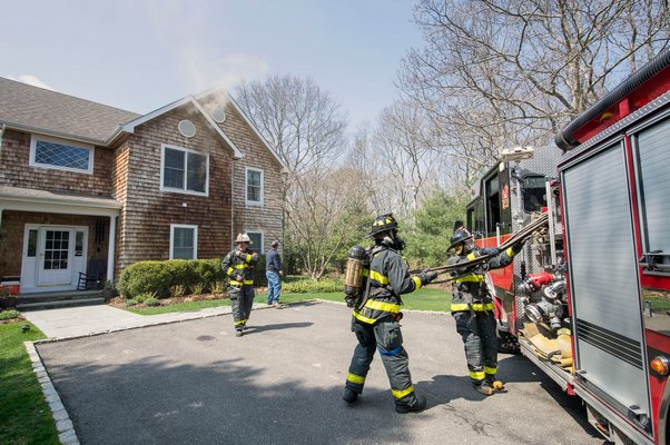 East Hampton firefighters put out a bedroom fire at a Fetlock Drive house. MICHAEL HELLER
