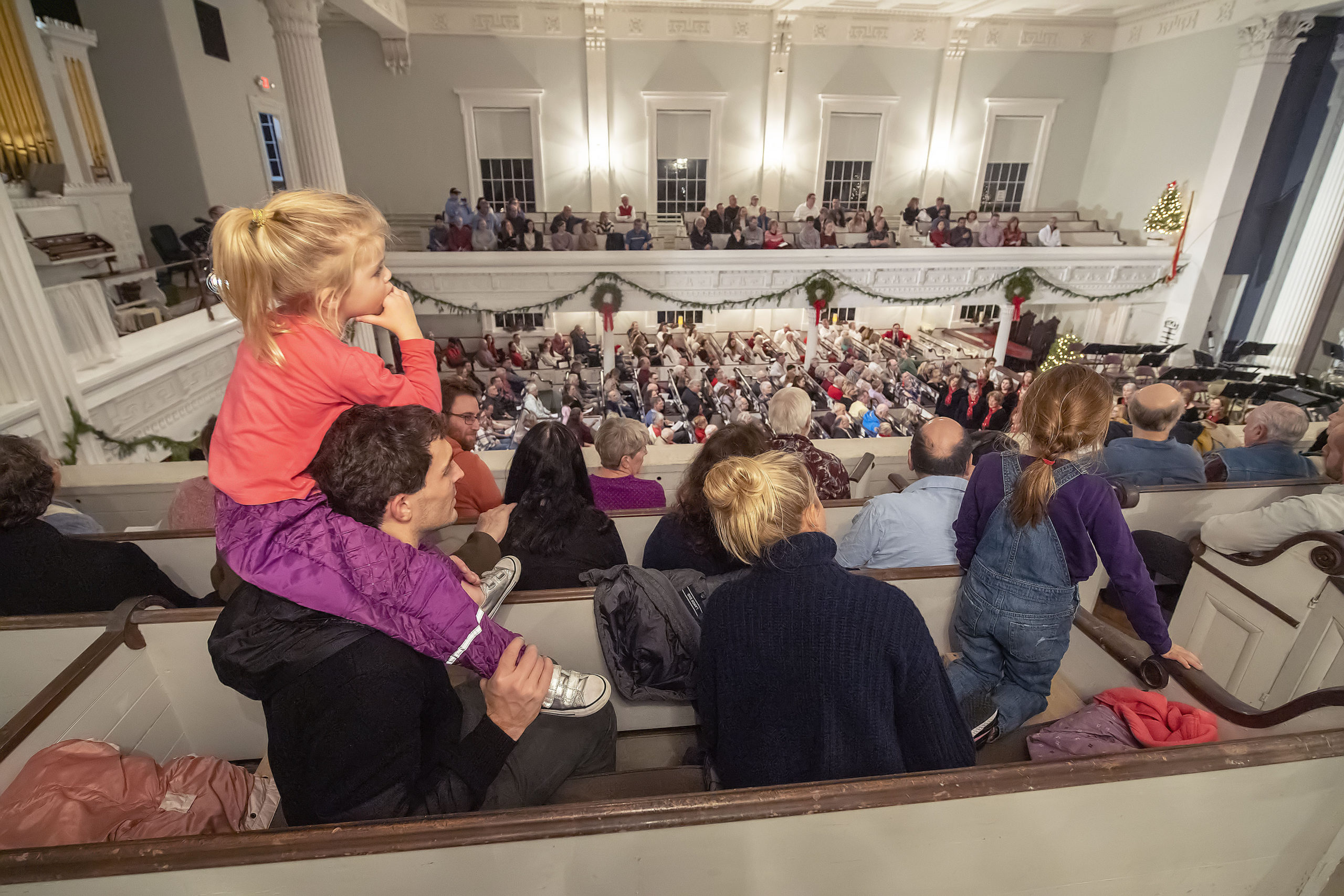 A little one gets a birds-eye view from the balcony during the Annual Holiday Concert at the First Presbyterian 