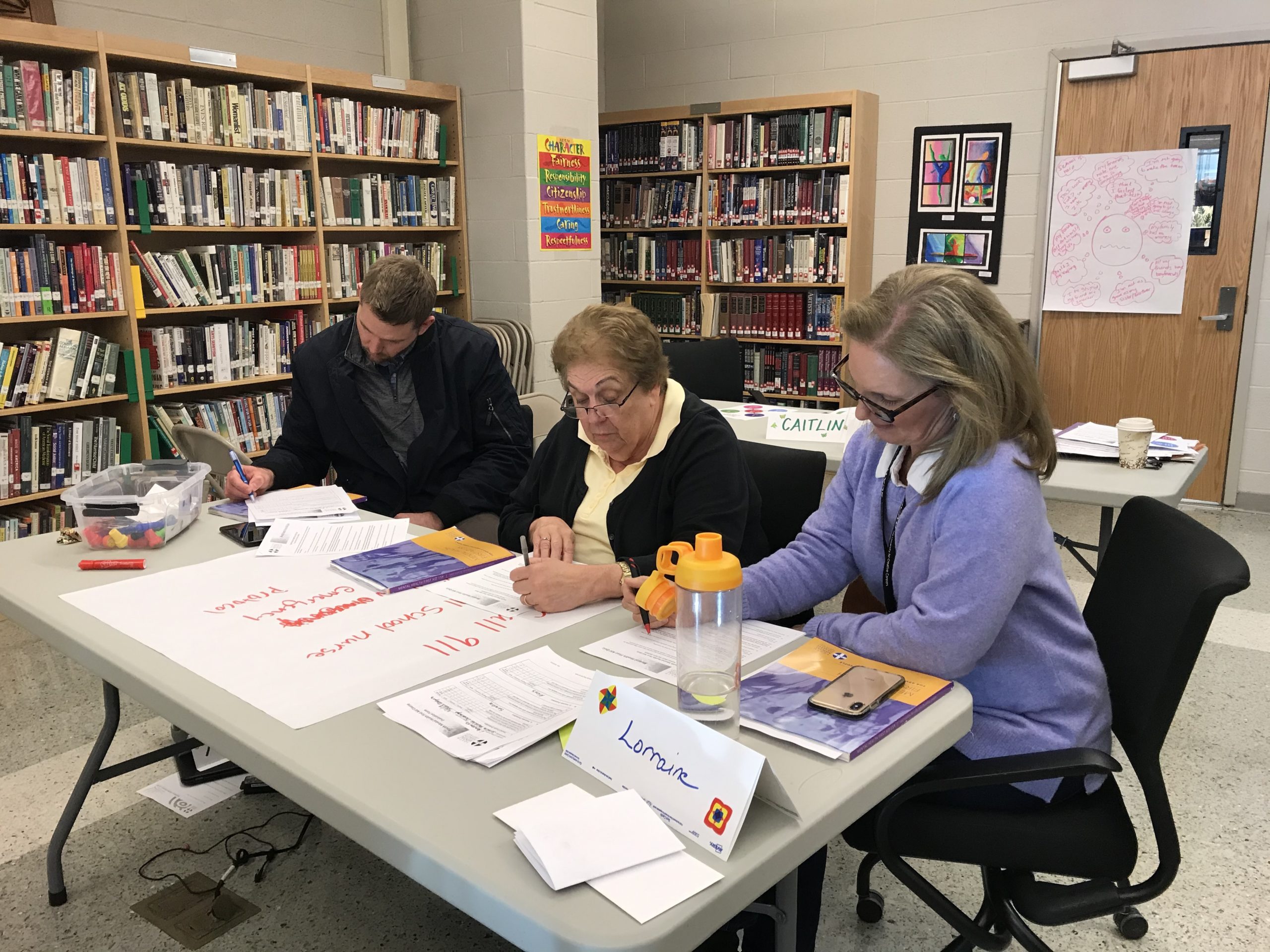 Psychologists, police officers, counselors, and staffers at East Hampton High School completed a Mental Health First Aid counseling program on Friday.  ELIZABETH VESPE