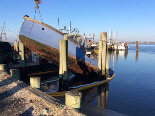 A sinking 40-foot fishing vessel was pulled from the Shinnecock commercial fishing docks on December 23. COURTESY OF SOUTHAMPTON TOWN