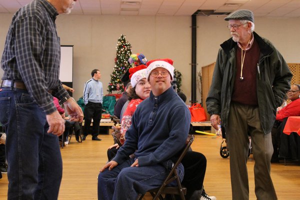  entertains his audience at the Hampton Bays Knights of Columbus annual holiday party for developmentally challenged adults and children Saturday afternoon in Hampton Bays. KYLE CAMPBELL