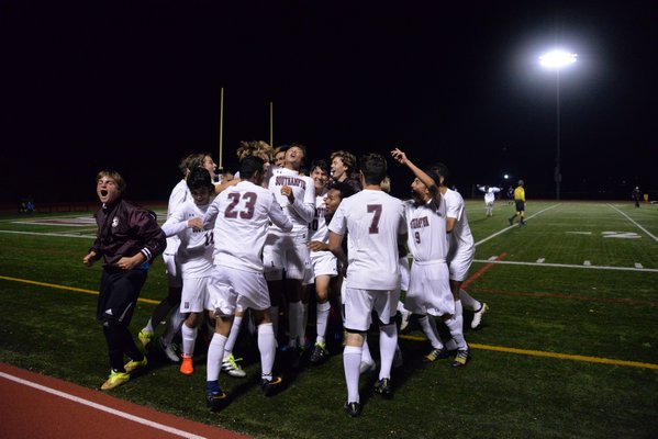 The Mariners celebrate their 4-3 overtime victory over Hampton Bays on Wednesday night. MICHELLE MALONE