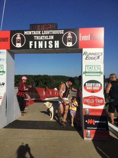  crosses the finish line as the winner of the Montauk Lighthouse Sprint Triathlon on Sunday. KIM COVELL