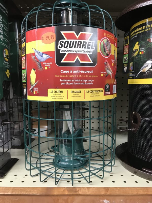 This bird seed feeder is simply a wire cage protecting the vertical seed tube in the center. It will keep the squirrels at bay, but it will also exclude larger birds like cardinals and jays.