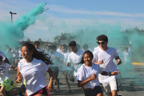 East Hampton High School held its third annual Color Run on Saturday morning, during which participants ran around the playing fields, being pelted by clouds of blue and pink dust. KYRIL BROMLEY