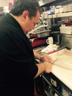 Chef Bryan Futerman of Nick and Toni's begins to slice the fresh fluke