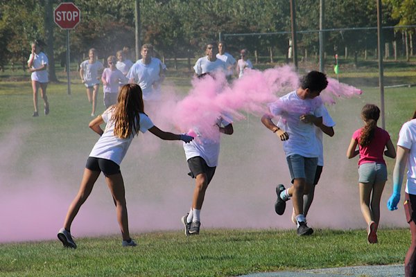 East Hampton High School held its third annual Color Run on Saturday morning, during which participants ran around the playing fields, being pelted by clouds of blue and pink dust. KYRIL BROMLEY