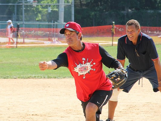 Benito Vila on the mound for the writers at the 67th Annual Artists and Writers Charity Softball Game at Herrick Park in East Hampton Village on Saturday. For more