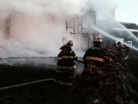 Firefighters battle a blaze in Sagaponack early Monday morning.