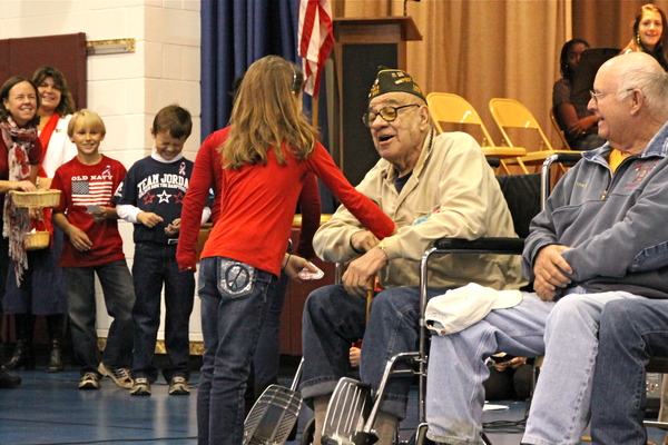 Tony Cangiolosi received a token of thanks from Stella McCormack at a ceremony honoring war veterans at the John Marshall Elementary School in East Hampton on Friday. 