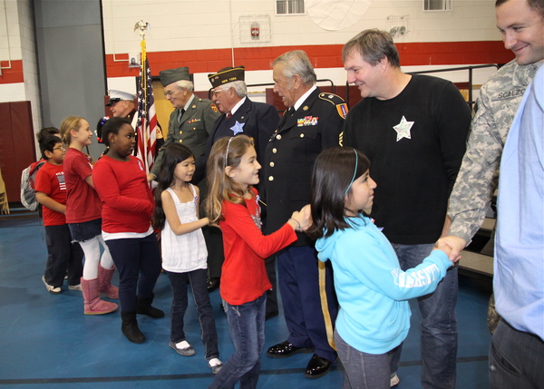 John Marshall Elementary School students shook the hands of veterans at a ceremony in their honor on Friday.