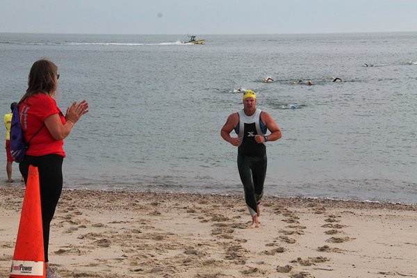 Some of the first competitors come out of the water of the swim. KYRIL BROMLEY