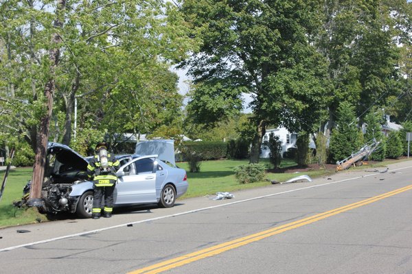 A car crashed into two utility poles shortly before 2 p.m. on Friday on Montauk Highway close to the intersection of South Country Road on Quiogue. BY CAROL MORAN