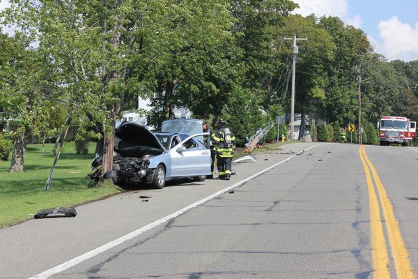 A car crashed into two utility poles shortly before 2 p.m. on Friday on Montauk Highway close to the intersection of South Country Road on Quiogue. BY CAROL MORAN