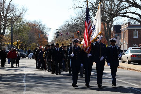Veterans marched down East Hampton’s Main Street to the Hook Mill Green to observe Veterans Day on Sunday. Afterward