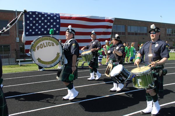 The Eastern Long Island Police Pipes and Drums band marches during the opening ceremony of the Long Island Region Special Olympics on Sunday at Southampton High School. KYLE CAMPBELL