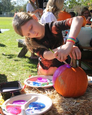 Ellie Lefton decorates a pumpkin.