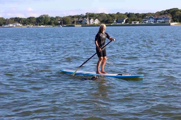 Diane Fisher and Huckleberry paddling around Smith Creek in Hampton Bays. JACK SULLIVAN