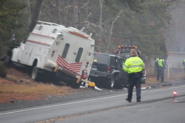 Southampton Town Police and New York State Troopers at the scene of a fatal crash on Flanders Road Thursday morning. BY CAROL MORAN