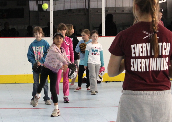 Elle Johnson practices her throw at a Little League clinic at the Sportime arena in Amagansett on Sunday.