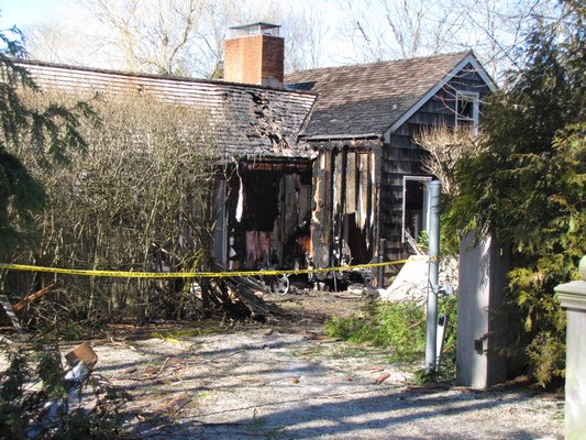 A house at the corner of Hayground Road and Mecox Road in Water Mill was badly damaged by flames after a car careened through the intersection and crashed into the home about 1 a.m. on Sunday morning. A family was asleep in the house but was not injured. Michael Wright