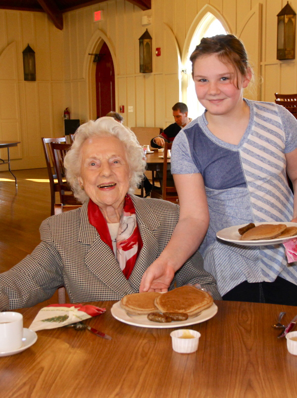 Camilla Jewett gets service with a smile from Sammi Schurr at the St. Luke's Episcopal Church pancake breakfast on Sunday.