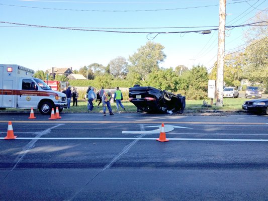 Police on the scene at a rollover near Sagg Main Street and Montauk Highway in Sagaponack Monday afternoon. MICHAEL WRIGHT