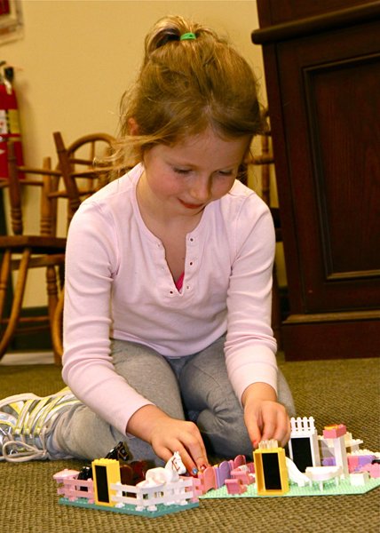 Mariella Narvilas customizes her favorite Lego setting at the Amagansett Library.