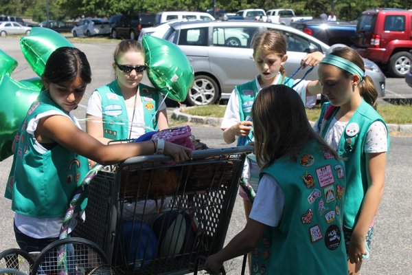 Girl Scout Troop 468 sets up a sports equipment rental station in Red Creek Park on Sunday morning. KYLE CAMPBELL