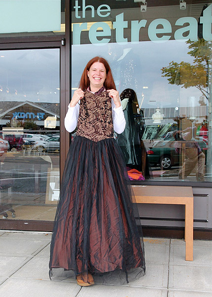 Heather Dunn-Kostura with her own wedding dress at the Retreat's thrift shop in Bridgehampton. KYRIL BROMLEY