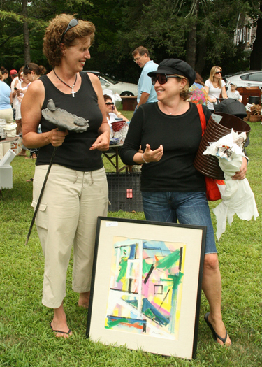 Discussing their finds at the The Jewish Center of the Hamptons annual Giant Yard Sale Sunday are Debra Siffert