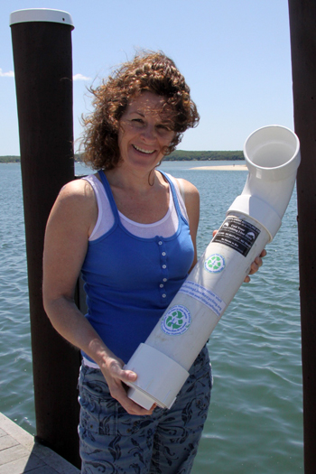 Debbie Klughers with a recycling canister similar to one that she hopes will be placed at the town dock at Gann Road.