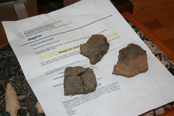 Potters shards found in Fort Pond rest on a PayPal  statement for a $1