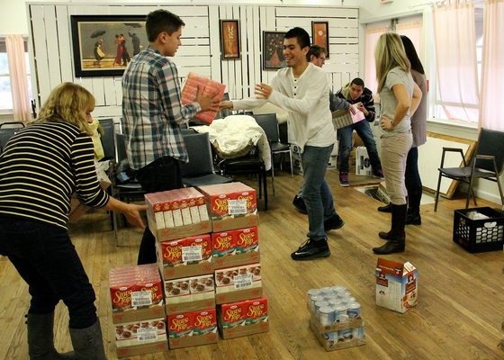 Volunteers pack bags of food for the Thanksgiving holiday at the East Hampton Food Pantry on Monday. KYRIL BROMLEY