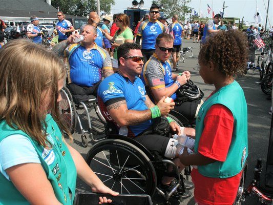 Girl Scout Troop 152 brought welcome water and fruit to the vets on a steamy day. KYRIL BROMLEY