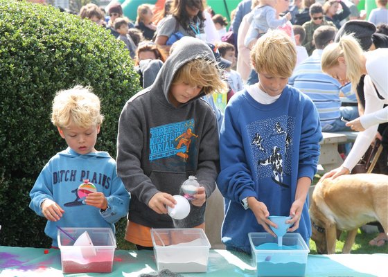 Making a sand art project at the Montuak Fall Festival.