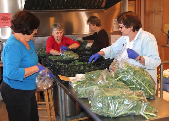 Volunteers at the Springs Food Pantry packing vegetables at the Springs Community Presbyterian Church. KYRIL BROMLEY