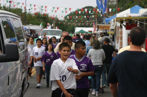 Hampton Bays soccer players walk through the festival ground during last year's San Gennaro Feast. KYLE CAMPBELL