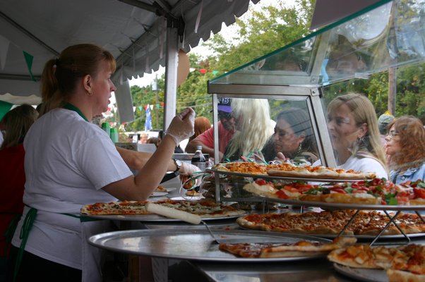 The Scotto's Pork Store tent served up fresh slices of pizza during last year's San Gennaro Feast of the Hamptons festival in Hampton Bays. KYLE CAMPBELL
