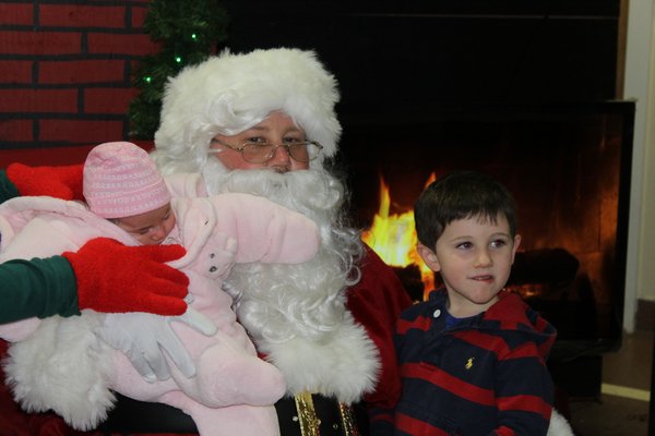  and her brother Parker meet Santa on Sunday night inside the Hampton Bays firehouse. KYLE CAMPBELL