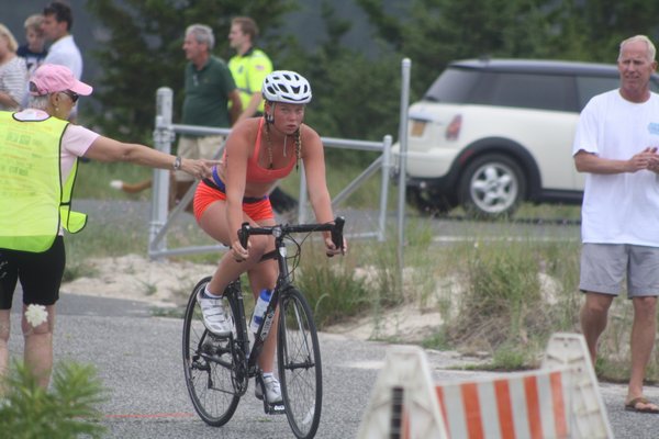 Maggie Purcell was the first out of the water and off the bike before being overtaken in the run to finish second in the Hamptons Youth Triathlon in Sag Harbor on July 14. CAILIN RILEY