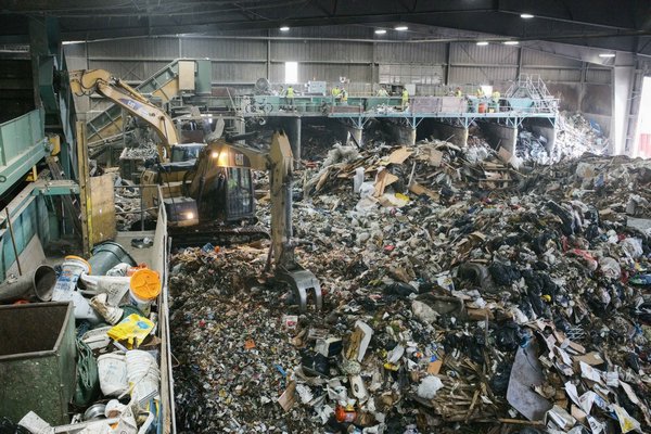 A team of four men is responsible for recovering any recyclables of value (mainly cardboard) from the waste stream at Paumanok Environmental in Yaphank. JOSEPH P. LOUCHHEIM
