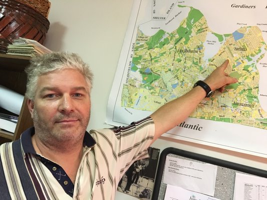 Martin Drew points to the hamlet of Springs on a map of East Hampton Town. LAURA WEIR
